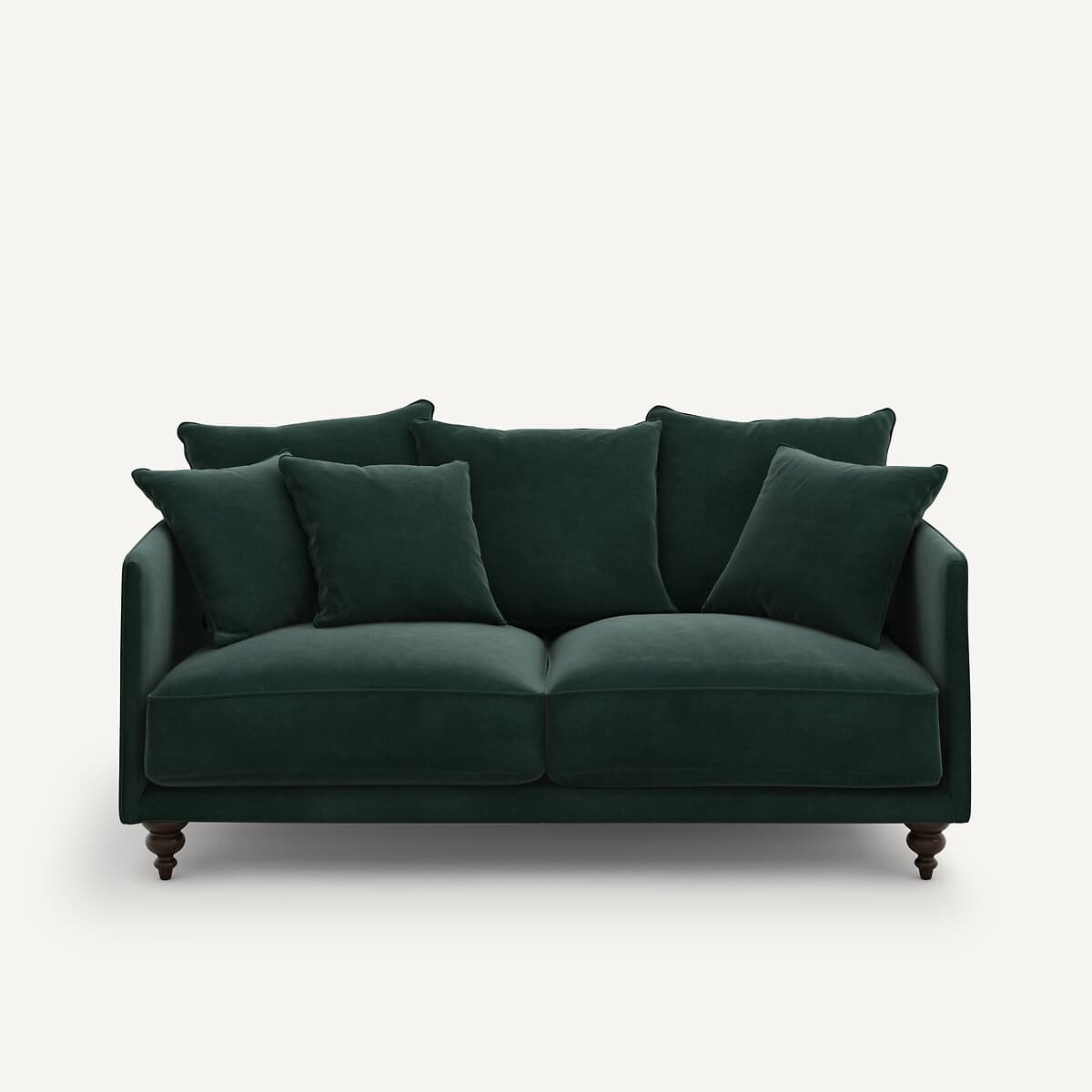 Sofá de terciopelo verde oscuro con cojines